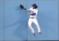  ?? MARK J. TERRILL — THE ASSOCIATED PRESS ?? Dodgers center fielder Cody Bellinger makes a catch at the wall on a ball hit by Texas Rangers’ Joey Gallo during the second inning.