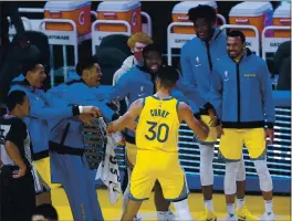  ?? TONY AVELAR — THE ASSOCIATED PRESS ?? Golden State Warriors guard Stephen Curry (30) celebrates with teammates on the bench after he scored his career-high 62 points against the Portland Trail Blazers in San Francisco on Sunday.