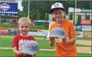  ?? NICHOLAS BUONANNO — NBUONANNO@TROYRECORD.COM ?? Patrick, left, and Andrew Borgman of Clifton Park show off the autographs they collected from players prior to the New York-Penn League All-Star Game on Tuesday night at Joseph L. Bruno Stadium in Troy.