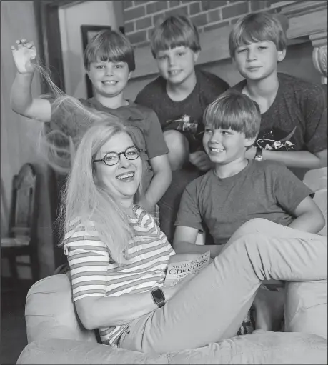  ?? Arkansas Democrat-Gazette/JOHN SYKES JR. ?? Betsy Singleton Snyder plays with her boys (clockwise from Singleton) Sullivan and triplets Wyatt, Penn and Aubrey Singleton Snyder. The pastor of preaching and missions at Pulaski Heights United Methodist Church in Little Rock is the author of the...