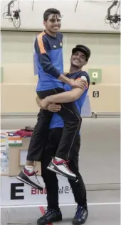  ?? Via Web ?? Saurabh Chaudhary, men’s 10m air pistol winner, is hoisted by bronze medallist Arjun Singh Cheema at the Changwon Shooting Range in South Korea. —