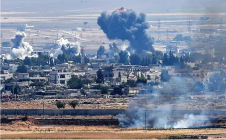  ?? AFP ?? Smoke rises from the Syrian town of Ras Al-Ain on the sixth day of Turkey’s military operation against Kurdish forces.