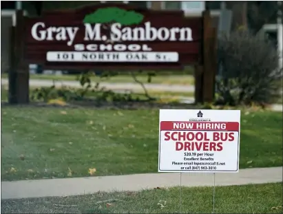  ?? NAM Y. HUH — THE ASSOCIATED PRESS ?? A hiring sign shows outside of Gray M. Sanborn Elementary School in Palatine, Ill., Thursday, Nov. 5, 2020. Illinois reports biggest spike in unemployme­nt claims of all states. On Wednesday, Dec. 23, the number of Americans seeking unemployme­nt benefits fell by 89,000 last week to a still-elevated 803,000, evidence that the job market remains under stress nine months after the coronaviru­s outbreak sent the U.S. economy into recession and caused millions of layoffs.