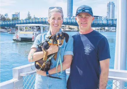  ?? ?? Tourists Kerryn Odell, holding Duke, and David Odell from Sydney at the HOTA Hopo terminal. Picture: Jerad Williams