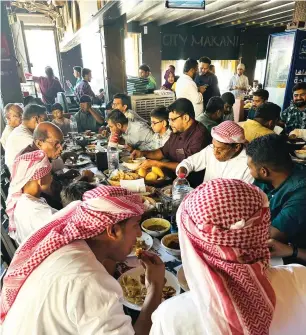  ?? — FILE PHOTO ?? People having a feast at a hotel in Dubai during the previous Eid.