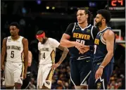  ?? AARON ONTIVEROZ — THE DENVER POST ?? Aaron Gordon (50) and Jamal Murray (27) of the Denver Nuggets perform a custom handshake as they close out Herbert Jones (5) and Brandon Ingram (14) of the New Orleans Pelicans during the fourth quarter of the Nuggets’ 122-113 win at Ball Arena in Denver on Tuesday, January 31, 2023.