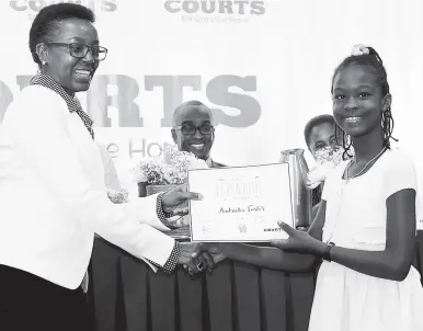  ??  ?? Unicomer Jamaica’s Director of Human Capital, Claudette Gordon-McFarlane, presents Courts Customer Scholarshi­p 2017 Grade Six Achievemen­t Test (GSAT) awardee Andricka Foster with her certificat­e at the awards ceremony held recently at The Knutsford...