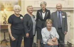  ??  ?? 0 Lillian Malcolm, front, with Theresa May and other MS volunteers