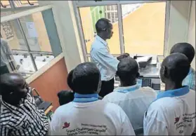  ??  ?? Healing business: Mental health patients help out in the photocopy and printing shop in Machakos, Kenya, to aid their rehabilita­tion