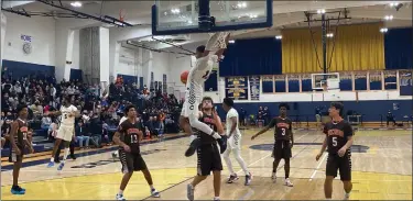  ?? MIKE CABREY/MEDIANEWS GROUP ?? Cheltenham’s Justin Savage with a slam dunk of an alley-oop pass from Rasheem Dearry during the Panthers’ District 1-6A second round game against Perkiomen Valley on Tuesday.