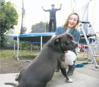  ?? Liz Hafalia / The Chronicle ?? Melody Nichols, who got a month’s rent paid, and son Angel are with Leo in their yard in San Francisco.