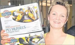  ?? GUARDIAN FILE PHOTO ?? Esther Dockendorf­f, president of P.E.I. Mussel King, holds some of the flavours the Morell processing company is now marketing to the world.