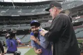  ?? Carlos Avila Gonzalez / The Chronicle ?? Bruce Bochy clowns around with Sergio Romo before the game as the longtime Giants reliever returned to AT&T Park wearing rival colors.