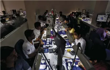  ?? (Amit Dave/Reuters) ?? CRAFTSMEN WORK in the polishing department of a diamond processing unit at Surat in Gujarat, India, on August 31, 2015.