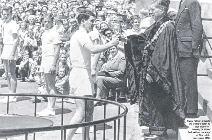  ??  ?? Frank Palmer presents the Olympic torch to then mayor of Geelong Cr Albert Backwell on the steps of City Hall in November 1956.