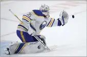  ?? NICK WASS — THE ASSOCIATED PRESS ?? Buffalo Sabres goaltender Linus Ullmark (35) reaches for the puck during a shootout against the Washington Capitals, Sunday in Washington.