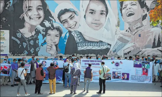  ?? Mariam Zuhaib The Associated Press ?? Former Afghan interprete­rs hold placards during a demonstrat­ion Friday in front of the U.S. Embassy in Kabul, Afghanista­n.