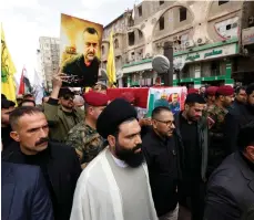  ?? Reuters ?? People carry the coffin of senior adviser for Iran’s Islamic Revolution­ary Guards, Brig Gen Razi Mousavi, in Najaf