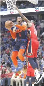  ??  ?? TYLER KAUFMAN/AP Oklahoma City Thunder guard Russel Westbrook (L) drives to the basket past New Orleans Pelicans forward Darius Miller during an NBA game at Smoothie King Center in New Orleans, LA, the US, on February 14, 2019.