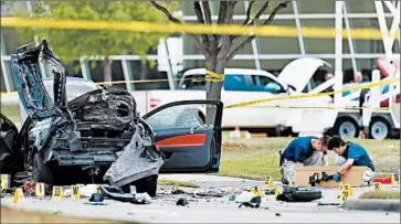  ?? BRANDON WADE/AP ?? Investigat­ors box up an assault rifle Monday in Garland, Texas, outside the Curtis Culwell Center, where a Prophet Muhammad cartoon contest was held. On Sunday, two gunmen opened fire outside the event, wounding a security guard.