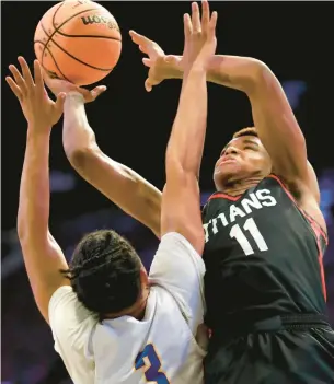  ?? STEPHEN M. KATZ/STAFF ?? Lake Taylor’s Elijah Washington puts up a shot against Hopewell’s Shawn Long during Tuesday night’s Class 3 Region A championsh­ip game at Scope.