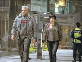  ?? PARAMOUNT ?? Pilou Asbaek and Scarlett Johansson take a stroll during one of the tamer moments in the film.