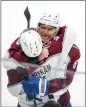  ?? AMBER BRACKEN — AP ?? Colorado Avalanche's Erik Johnson hugs Bowen Byram after the team beat the Edmonton Oilers in overtime last week. The Avalanche won the game 6-5, to take the series.