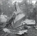  ?? THE ASSOCIATED PRESS ?? This file photo shows the wreckage of a plane in a wooded area near McComb, Miss., where six people were killed, including three members of the music group Lynyrd Skynyrd.