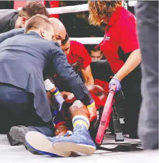  ?? PHOTOS: JON DURR-USA TODAY SPORTS ?? Patrick Day is tended to by paramedics after being knocked out by Charles Conwell (not pictured) during a USBA super-welterweig­ht boxing match at Wintrust Arena on Oct. 12.