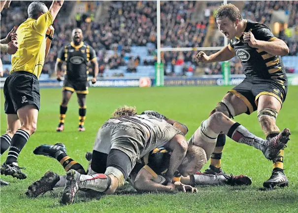  ??  ?? Decisive moment: Dan Robson manages to get himself over the line to seal a last-gasp victory for Wasps, and virtually guarantee their place in the knockout stage