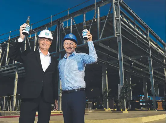  ?? CHEERS: Hutchinson chairman Scott Hutchinson and The Ville CEO Michael Jones in front of the new conference facility under constructi­on. Picture: EVAN MORGAN ??