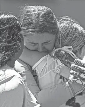  ?? AARON E. MARTINEZ/AMERICAN-STATESMAN ?? Rouse defender Mia Merz, center, hugs goalkeeper Kayla Hehenberge­r after the Raiders’ Class 5A state semifinal loss to Frisco Wakeland 4-2 on penalty kicks. “We had some close ones (Thursday), but the girls left it all on the field,’’ Rouse coach Corey Elrod said.