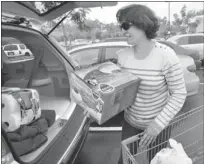  ?? DAN ROSENSTRAU­CH/ STAFF ?? Nasrin Akrami, ofWalnut Creek, loads up her car Friday after shopping at Walmart in Martinez.