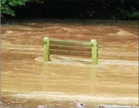  ?? PHOTO SUBMITTED BY LORI ROHRBACH ?? No one wanted to sit on this bench as Hay Creek burst its bank and flooded Birdsboro’s Rustic Park on Monday, Aug. 13.