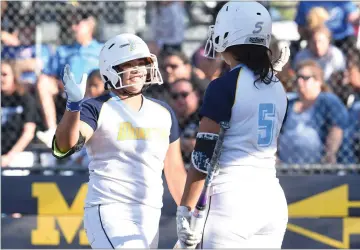  ?? RECORDER PHOTO BY CHIEKO HARA ?? Monache High School's Jessenia Castillo, left, and Taliann Hunter give each other a high five after Castillo scores a run Wednesday, May 16, during an opening round game of the CIF Central Section Division I Softball Championsh­ip tournament against...