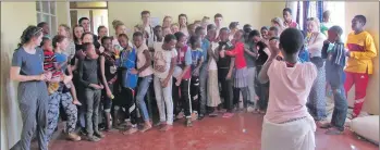  ??  ?? A group singing with the children from the Kimashuku orphanage.