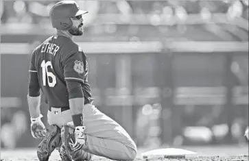  ?? Ross D. Franklin Associated Press ?? RIGHT FIELDER Andre Ethier kneels at second base after being thrown out trying to stretch a single into a double during a game against the White Sox. Ethier underwent an MRI exam on his sore lower back Monday.