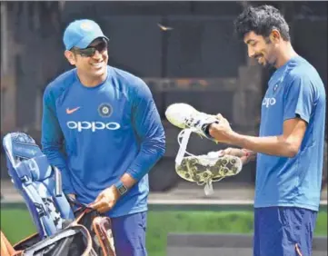 ?? AFP ?? MS Dhoni and Jasprit Bumrah during a training session ahead of the third ODI at the Holkar stadium on Saturday. India have a formidable record in Indore, winning all the four games they have played here.
