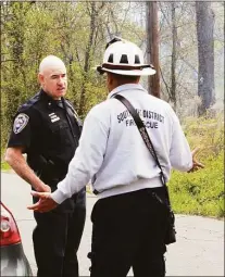  ?? ?? First responders discuss a brush fire off Freeman Road in Middletown on Wednesday.