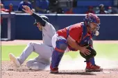  ?? JON BLACKER — THE CANADIAN PRESS ?? The Yankees’ Isiah Kiner-Falefa, left, slides safely into home ahead of a tag by Blue Jays catcher Alejandro Kirk, right, in the fourth inning on Saturday in Toronto.