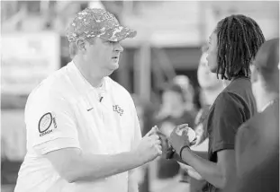  ?? PHELAN M. EBENHACK/AP ?? UCF coach Josh Heupel, left, and his staff have not been able to visit recruits in person, but the Knights have still landed key pieces for what could be a strong 2021 recruiting class.