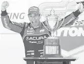  ?? JOHN RAOUX/AP ?? Helio Castroneve­s celebrates after winning the Rolex 24 hour auto race on Jan. 30 at Daytona Internatio­nal Speedway in Daytona Beach, Fla.