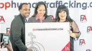  ??  ?? David Ayala, community organizer at LatinoJust­ice, left, his wife, Orange-Osceola State Attorney Aramis Ayala, center, and Frances Lee, Florida Abolitioni­st public-relations director, pose for photos during Thursday’s event in Orlando.