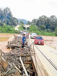  ??  ?? Back in use: Vehicles plying the Setelu bridge after it was reopened yesterday. — Bernama