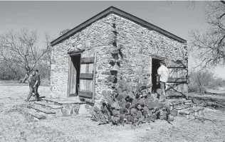  ?? Felicia Frazar / Seguin Gazette ?? Visitors walk around Hardscramb­le, checking out the work that was done to restore the 180-year-old building that served as a Ranger Station for some of the first Texas Rangers.