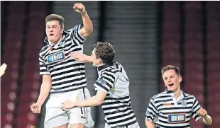  ?? Picture: SNS Group. ?? Sean Burns takes to the air to celebrates his goal against Dundee with Andy Robertson and Lawrence Shankland.