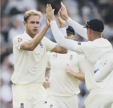  ??  ?? Stuart Broad, left, celebrates with team-mates after dismissing Murali Vijay at Edgbaston.