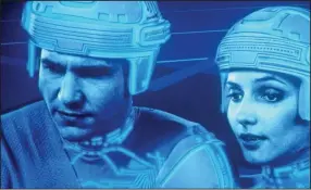  ??  ?? Jeff Bridges and Cindy Morgan star in “TRON,” Disney’s 1982 science-fiction film that was inspired by the early video game Pong.