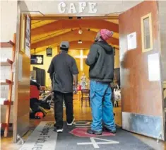  ?? STAFF PHOTO BY TIM BARBER ?? Two men enter the ReCreate Cafe at the Salvation Army. The organizati­on celebrates its 125th anniversar­y in Chattanoog­a this year.