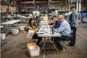  ?? ALEXANDRA WIMLEY/PITTSBURGH POST-GAZETTE ?? Allegheny County elections workers review provisiona­l ballots with authorized representa­tives from Dave McCormick and Dr. Mehmet Oz’s campaigns in Pittsburgh.